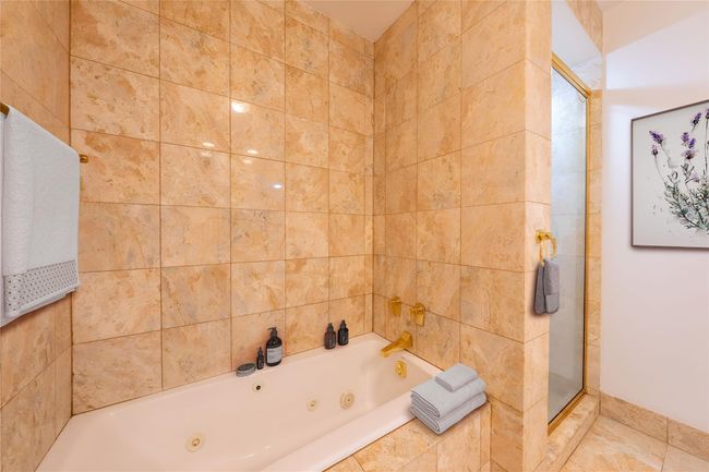 Full bathroom with a whirlpool tub and a stall shower | Image 8