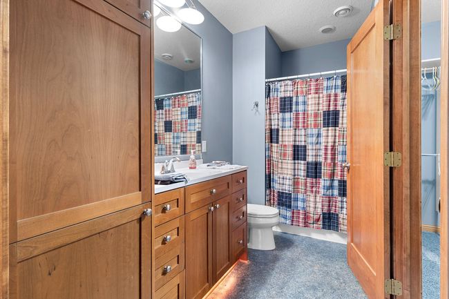 Lower-level first bedroom suite full bath with walk-in closet. | Image 53