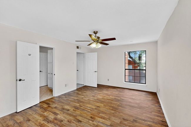 Unfurnished bedroom with wood finished floors, baseboards, and ceiling fan | Image 20