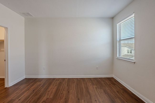 Empty room featuring baseboards, visible vents, and dark wood-style floors | Image 26