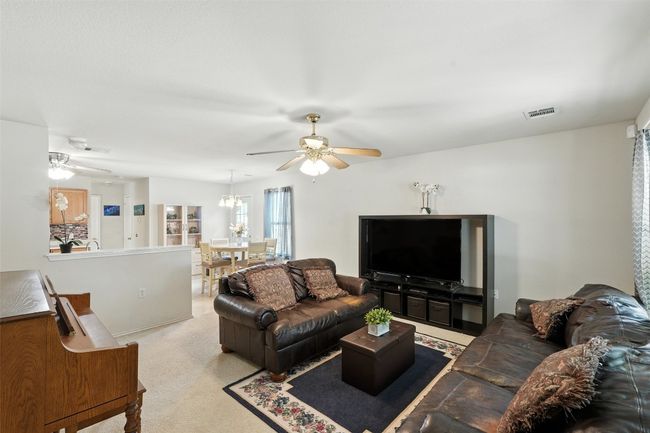 Carpeted living area with ceiling fan | Image 5