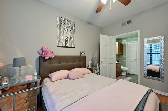 Bedroom featuring ensuite bathroom, wood-type flooring, and ceiling fan | Image 7