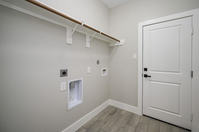 Utility Room Is Located Inside The Home, Next To The Garage, & Also Includes Shelving Above Respected Appliances | Image 18