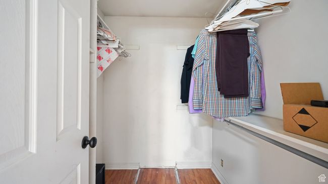 Walk in closet featuring wood finished floors | Image 16