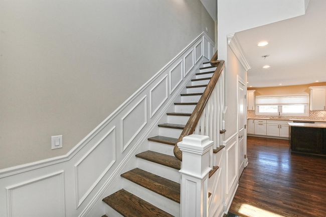 Stairway with wood finished floors, recessed lighting, and a decorative wall | Image 28