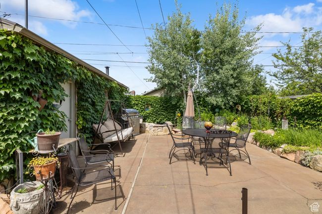 View of patio with outdoor dining area and a grill | Image 25