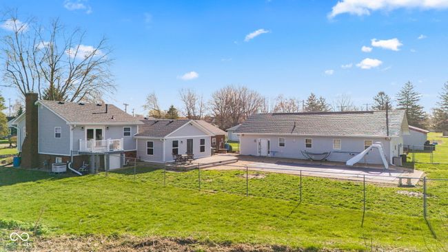 rear view of house featuring a fenced backyard, a deck, a patio, and a lawn | Image 64