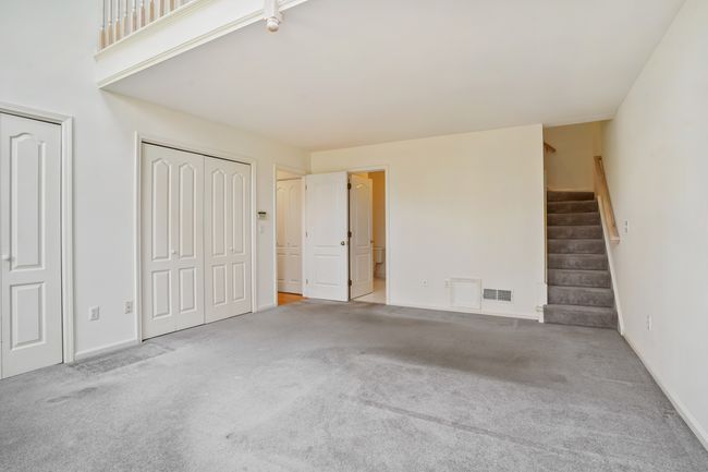 Primary bedroom with second staircase to upper level | Image 17