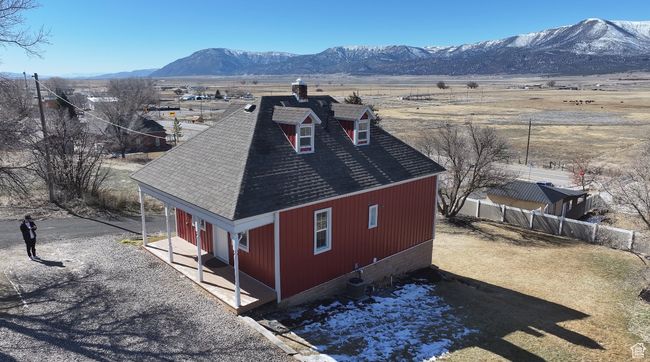 Exterior space with fence, a mountain view, and roof with shingles | Image 40