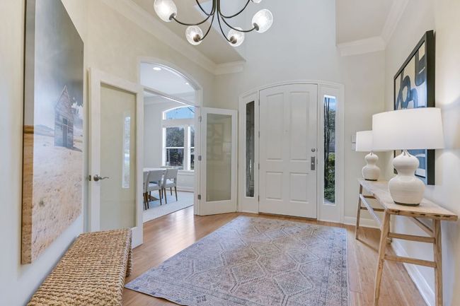 Entryway featuring ornamental molding, a chandelier, and bamboo floors | Image 4