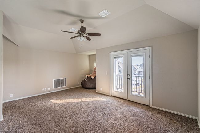 Unfurnished room with vaulted ceiling, carpet, ceiling fan, french doors, and baseboards | Image 24