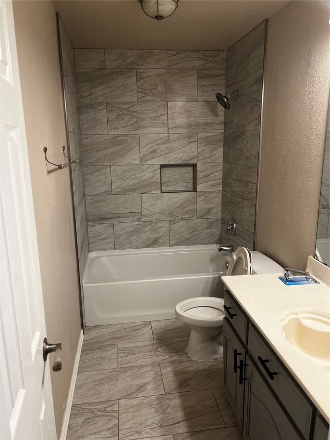 Bathroom featuring tub/ has been recently updated to include tile flooring and new tub/shower area. | Image 14