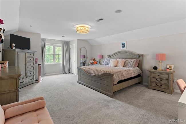 Bedroom featuring carpet, visible vents, vaulted ceiling, and baseboards | Image 33