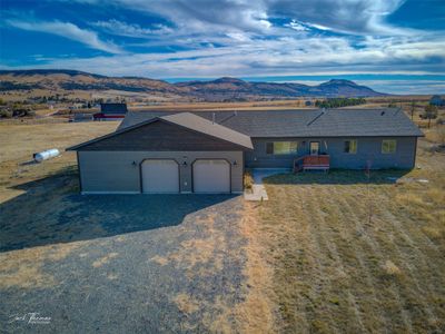 Ranch-style home featuring a mountain view and a garage | Image 1