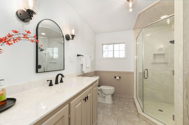 Elegant full bathroom featuring a spacious glass shower, modern fixtures, and stylish vanity for a luxury touch. | Image 31