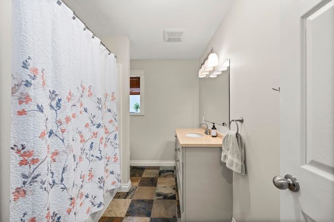 Bathroom featuring stone finish floor, vanity, baseboards, and a shower with curtain | Image 22