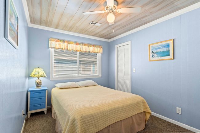Bedroom with carpet, a closet, crown molding, and ceiling fan | Image 17