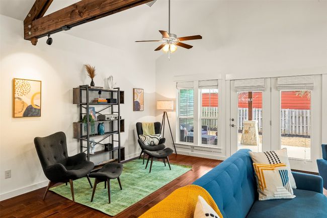 Living room featuring wood finished floors, a ceiling fan, track lighting, beamed ceiling, and high vaulted ceiling | Image 7