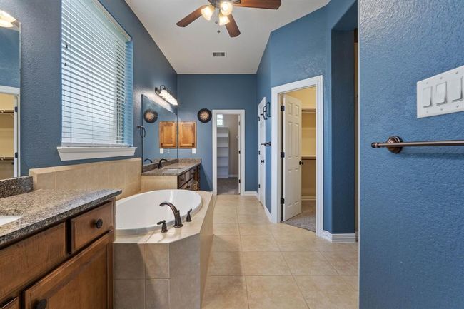 The primary bathroom has dual sinks and two walk-in closets. | Image 22