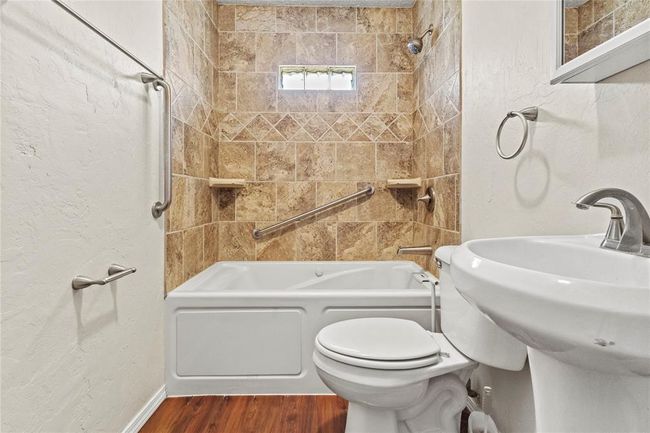 Bathroom featuring tiled shower / bath combo, wood-type flooring, and toilet | Image 18