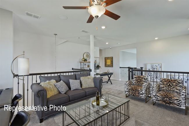 Carpeted living area featuring a ceiling fan, visible vents, and recessed lighting | Image 14