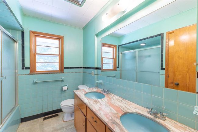Carpeted empty room with a ceiling fan, crown molding, and baseboards | Image 14