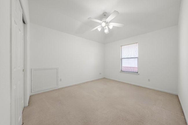 Unfurnished room with light carpet, baseboards, and ceiling fan | Image 15