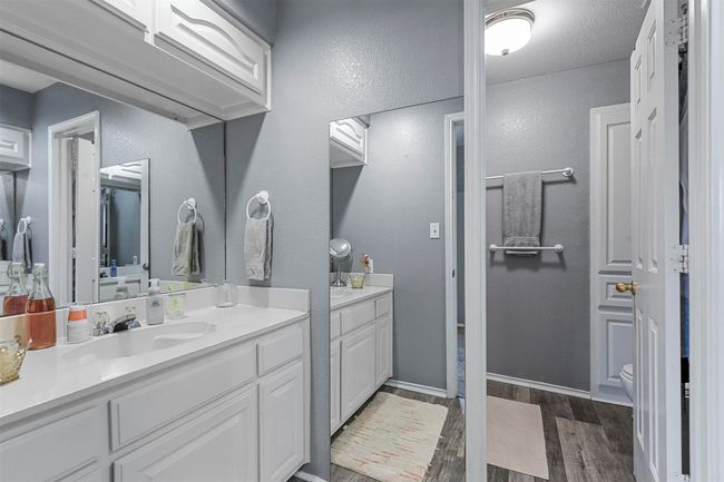 Bedroom with dark colored carpet and ceiling fan | Image 25