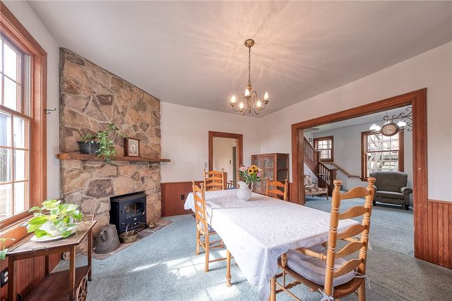 Spacious Dining area featuring a stunning stone fireplace with an electric insert, perfect for entertaining family and friends | Image 6