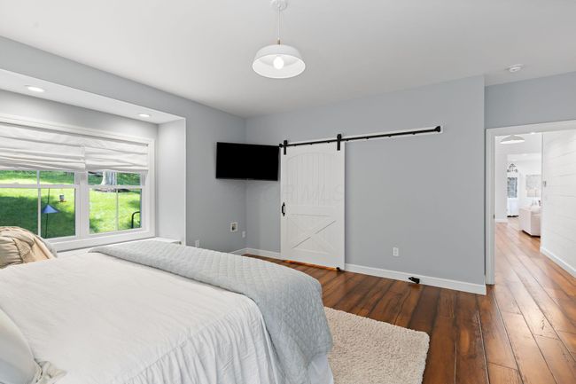 Walk-in-closet hides behind the barn door | Image 32