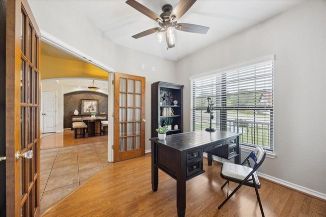 Double, glass doors bring you into this study/office. | Image 11