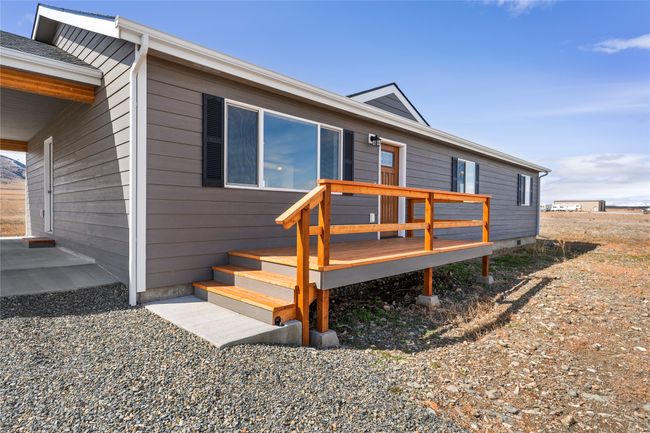 View of front of home with a wooden deck | Image 26