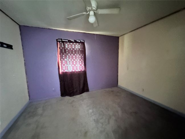Spare room with a ceiling fan and carpet flooring | Image 14