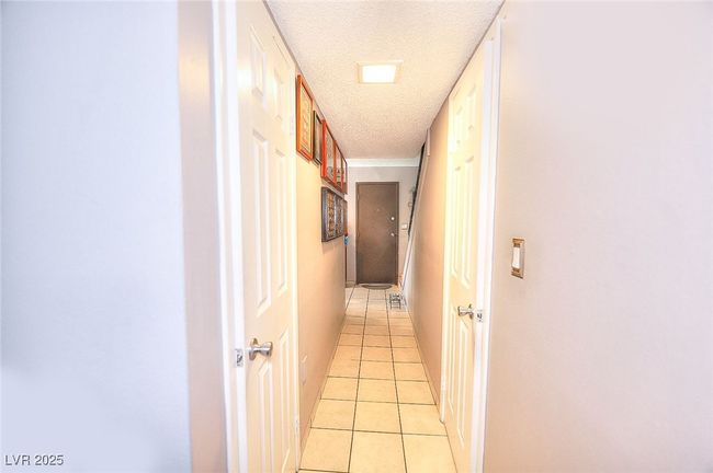 Hallway featuring tile floors | Image 9