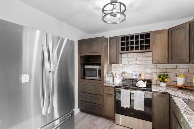 Spare room featuring light wood finished floors, ceiling fan, and baseboards | Image 5