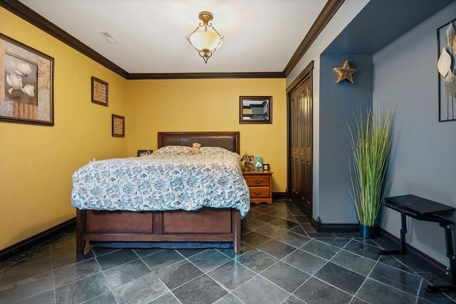 Bedroom with baseboards and crown molding | Image 27