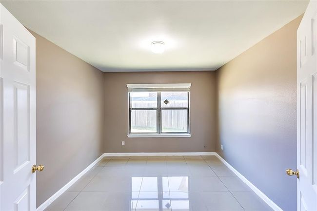 Spare room featuring light tile patterned flooring and baseboards | Image 8