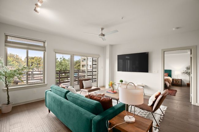 Living room with ceiling fan, baseboards, and wood finished floors | Image 21