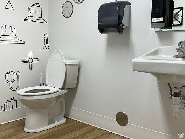 Bathroom featuring toilet, wood finished floors, and baseboards | Image 15