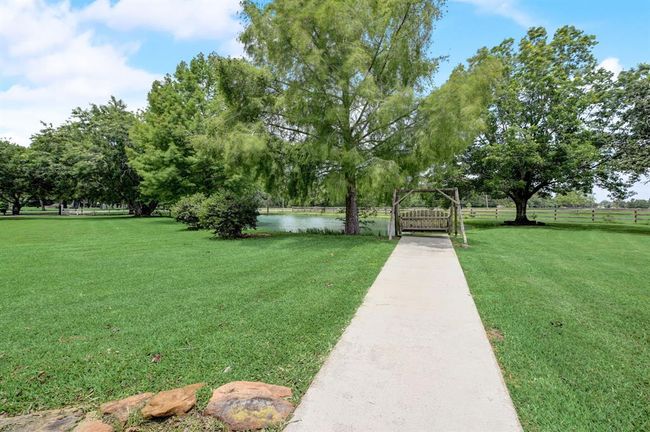 Pathway to the fully stocked pond. Enjoy fishing in your front yard or just feeding the fish. | Image 33