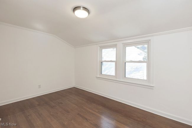 Spare room with lofted ceiling, hardwood / wood-style floors, and ornamental molding | Image 30