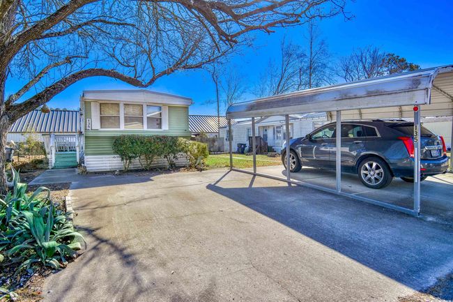 View of vehicle parking featuring a carport | Image 15