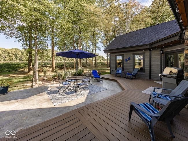 wooden deck with a patio, outdoor dining space, and area for grilling | Image 40