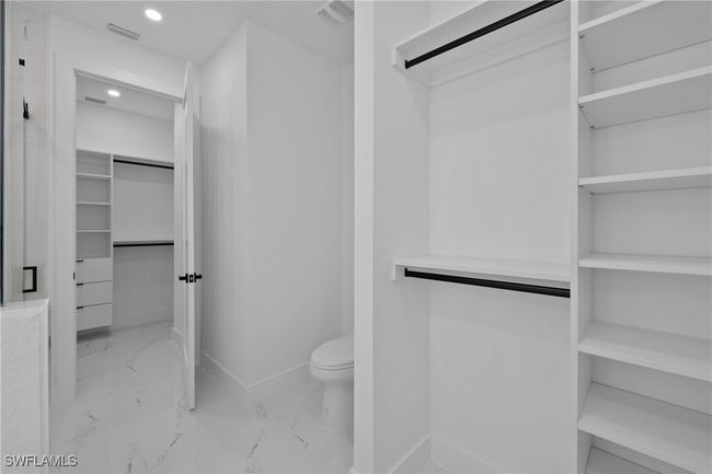 Spacious closet featuring marble finish flooring | Image 23