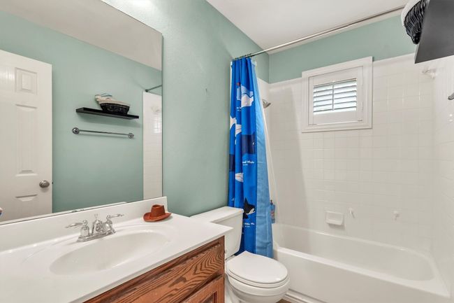 Bathroom featuring shower / bath combo, vanity, and toilet | Image 28
