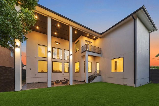 BACKYARD: The backyard is meticulously landscaped with verdant greenery, creating a picturesque backdrop that enhances the beauty of the home's architecture. Whether hosting summer barbecues or cozying up by a fire pit on cool evenings, the spacious backyard is designed for relaxation and enjoyment year-round. | Image 47
