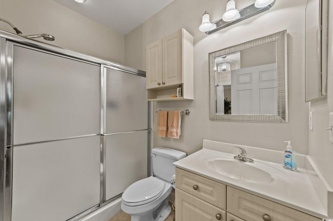 Bathroom featuring toilet, a shower stall, and vanity | Image 13