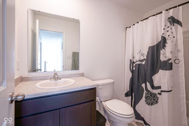bathroom with vanity and a shower with shower curtain | Image 26