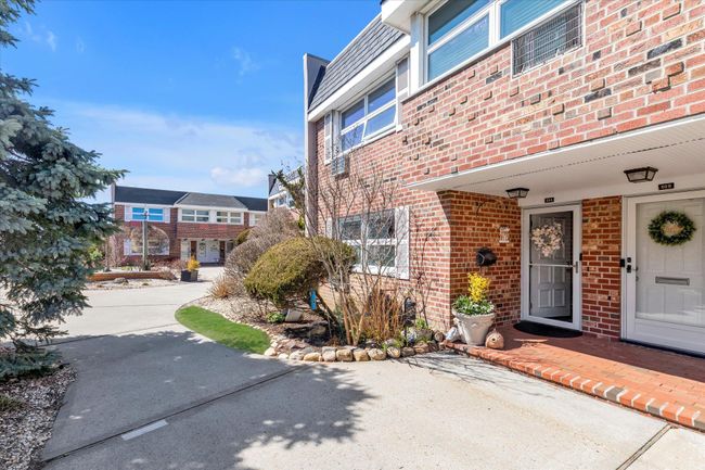 View of exterior entry featuring brick siding | Image 13