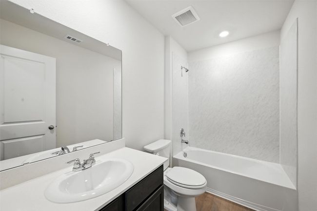 Full bath featuring vanity, wood finished floors, bathtub / shower combination, and recessed lighting | Image 18